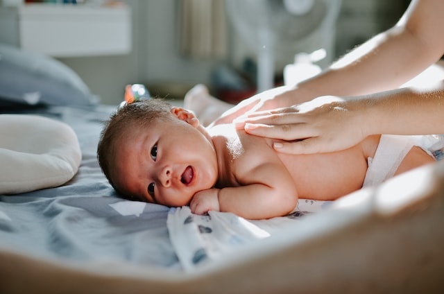 baby laying on the bed