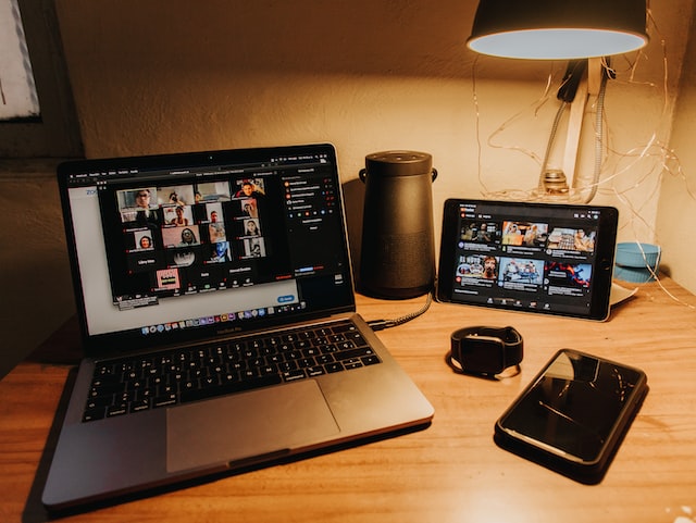 black and silver laptop on brown wooden table