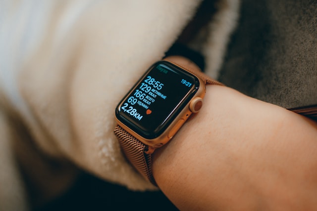 brown apple watch on the left persons hand