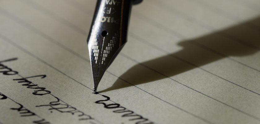 fountain pen on black lined paper