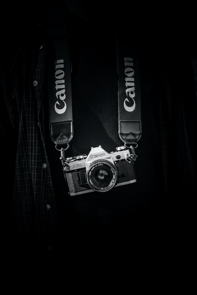 gray and black camera on the straps