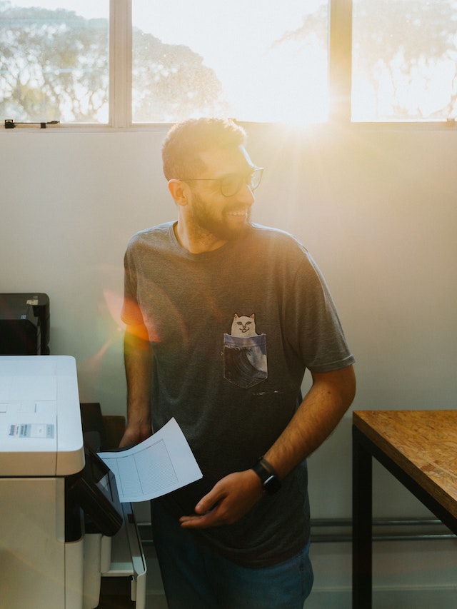 laughing person using printer