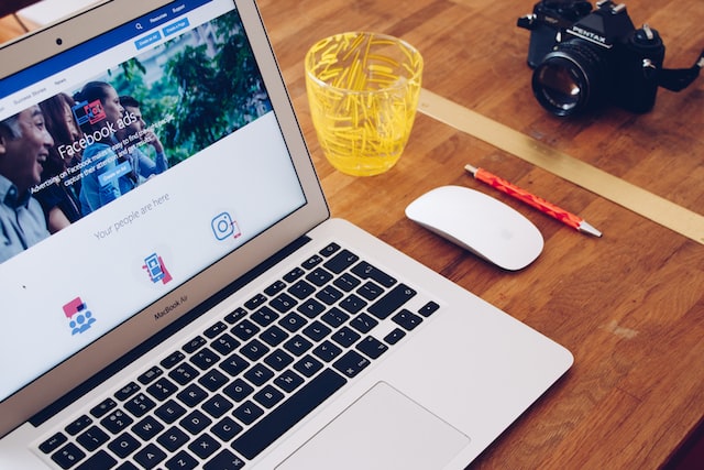 macbook with the facebook website opened on the table