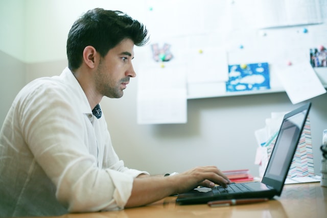 person editing document on laptop