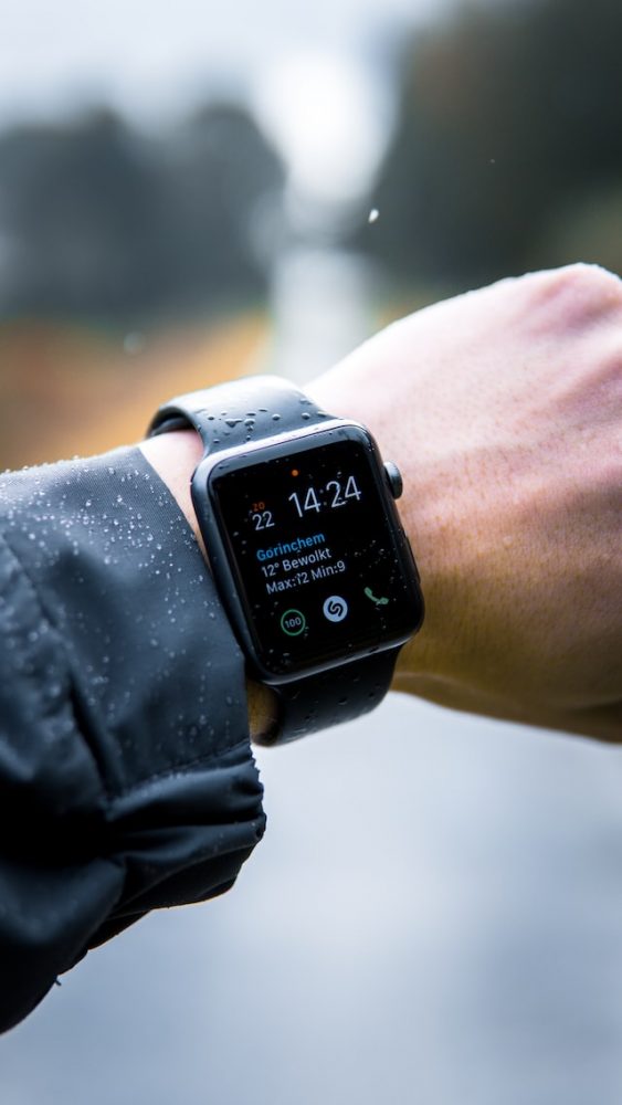 person holding apple watch in water