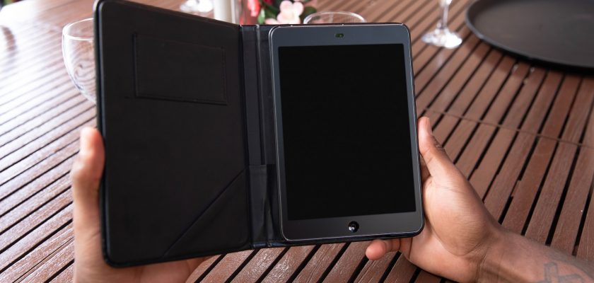 person holding black ipad