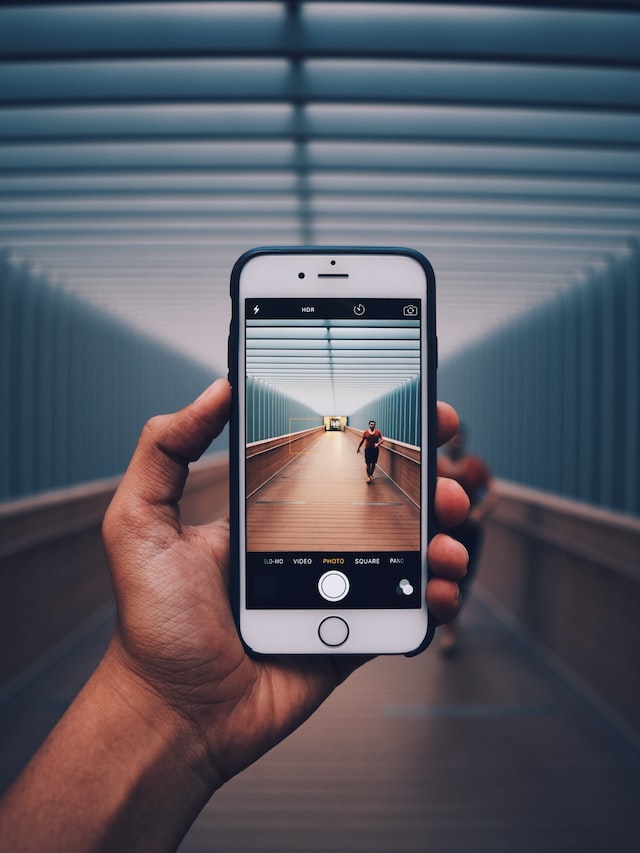 person holding the phone and capturing the video