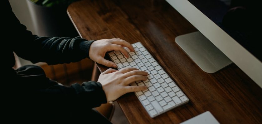 person using imac keyboard