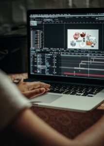 person using macbook on table