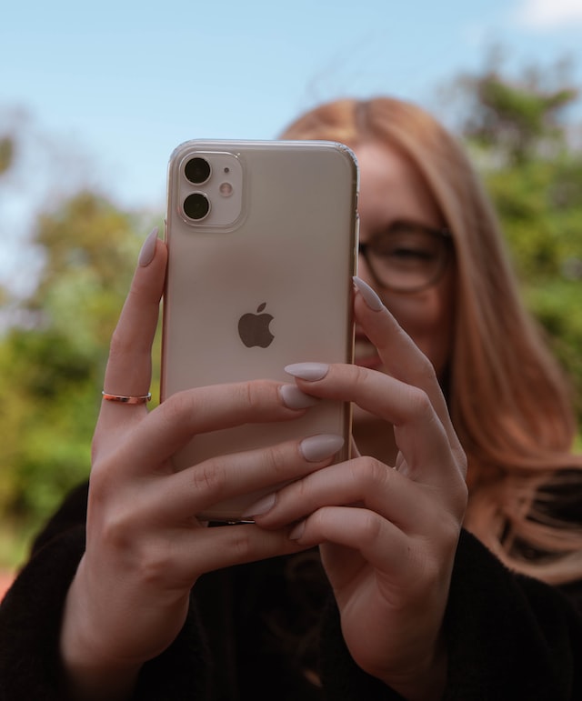 person using pink iphone