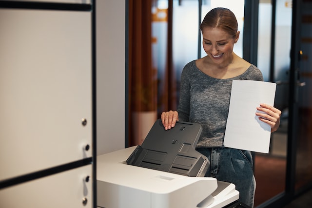 smiling person using the printer