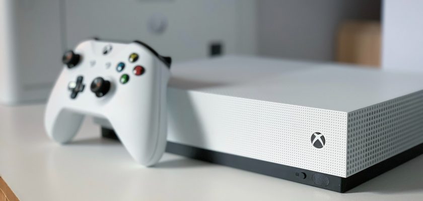 white xbox one console on table